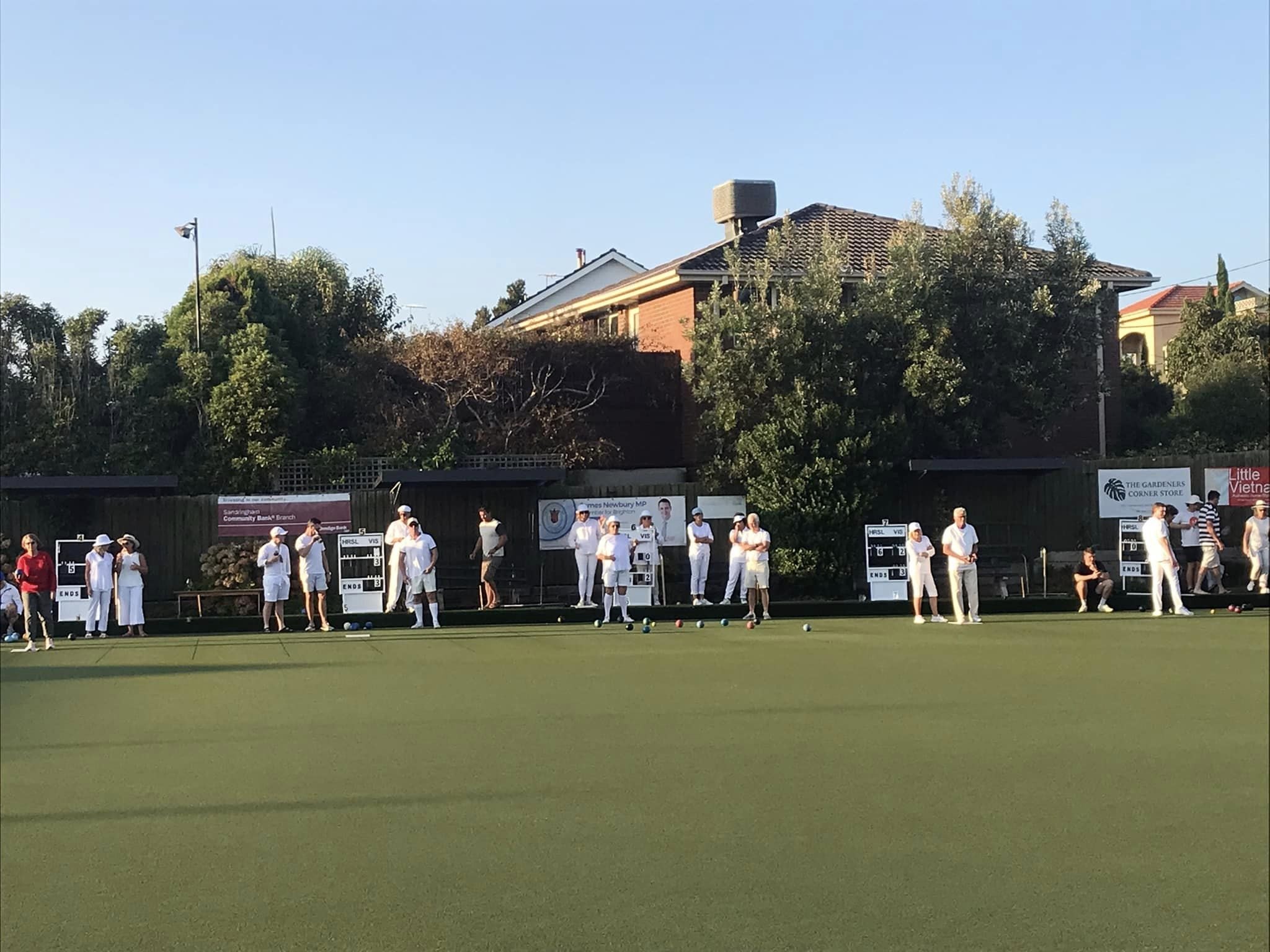 The full length of the green with players in whites on every rink